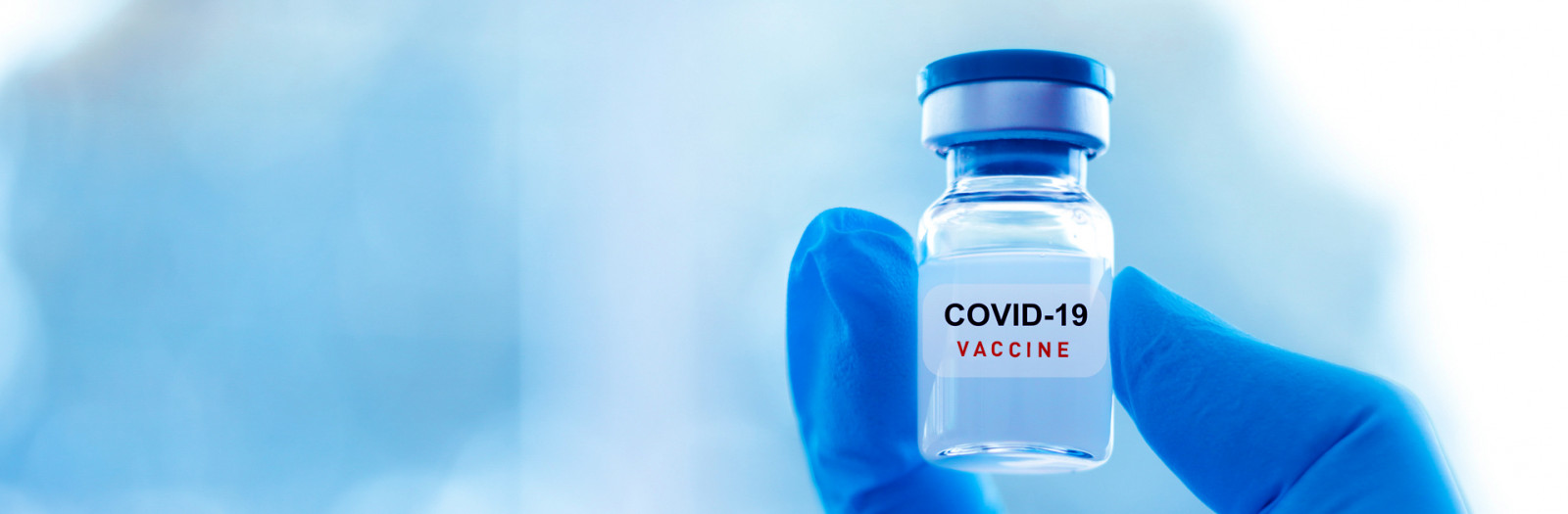 NPI - Vial in hand with Covid vaccine